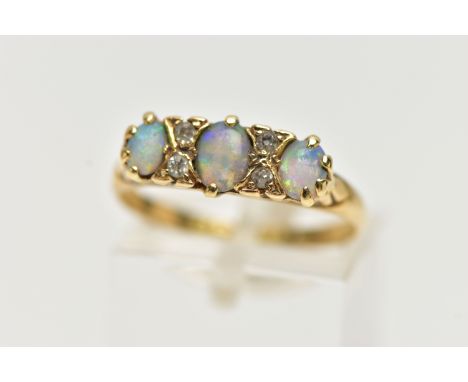 AN EARLY 20TH CENTURY 18CT GOLD, OPAL AND DIAMOND RING, designed with three oval opal cabochons, each interspaced with four s