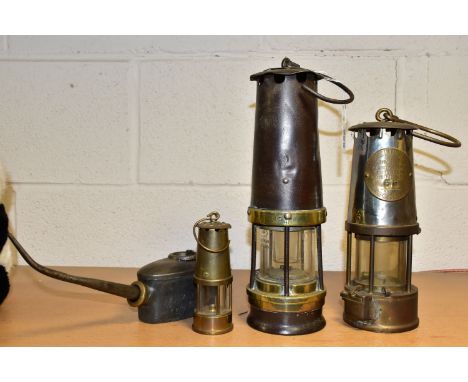 THREE MINERS' LAMPS AND AN OIL CAN, comprising a lamp by John Davis and Son, Derby, having brass plate to top also stamped 'A