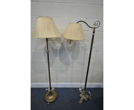 AN EARLY 20TH CENTURY BRASS FLOOR STANDING READING LIGHT, with a scrolled arm, height 167cm, with a fabric shade (condition:-