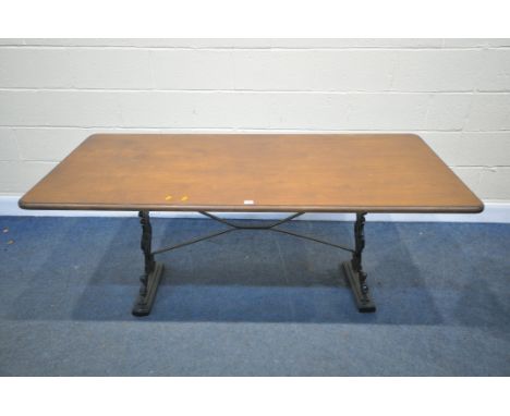 A VINTAGE CAST IRON TABLE, with a later wooden top, length 168cm x depth 77cm x height 72cm, width of base, 104cm x depth 36c