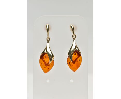 A PAIR OF 9CT GOLD, AMBER DROP EARRINGS, each designed as an oval amber drop in a yellow gold mount, post and scroll back fit