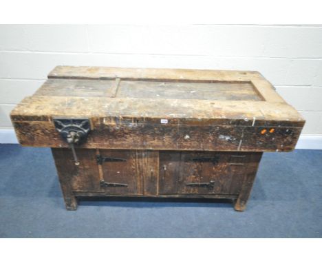 A VINTAGE WORKBENCH, with a Record No42 vice, above various cupboard doors, width 153cm x depth 86cm x height 76cm (condition