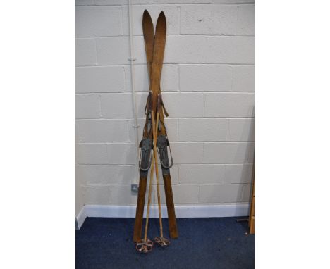 A PAIR OF VINTAGE WOODEN SKI'S branded with   Stratos   along with a pair of bamboo and leather ski poles