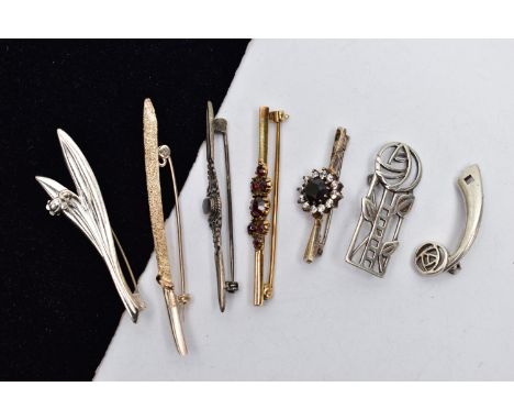 SEVEN BROOCHES, to include a silver openwork floral brooch, hallmarked Edinburgh, a gold plated bohemian garnet bar brooch, s