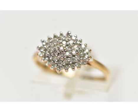 A 9CT YELLOW GOLD, DIAMOND CLUSTER RING, of a marquise shape, set with single cut diamonds, pinched shoulders leading onto a 