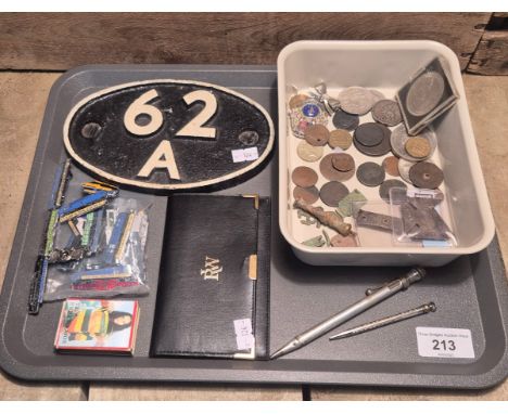 A Tray of collectables odds; Reproduction Resin Railway Sign. Railway loco badges. Raymond Weil purse. Nude scene matchbox. T