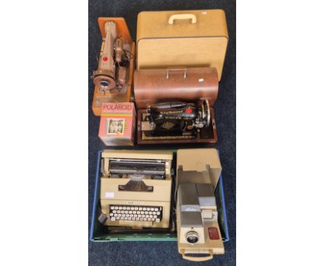 A collection of vintage collectables Two Vintage singer sewing machines, Olivetti letters 25 type writer, Polaroid boxed came