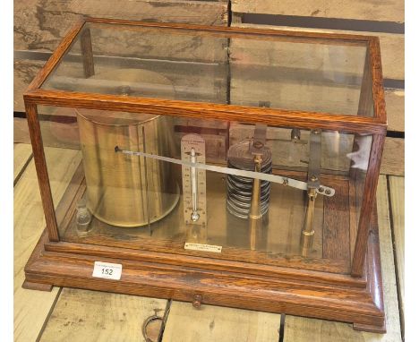 A Late 19th/ early 20th century brass and oak cased barograph. Produced by Negretti &amp; Zambra London. 30x49x28cm. This is 