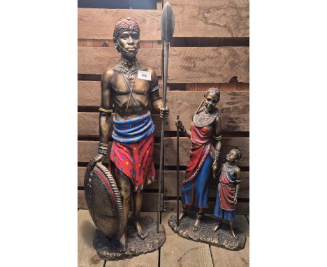 Two Large Masai Warrior Figures; Large Man warrior with shield &amp; spear. Woman holding child's hand figure. Tallest 65cm.