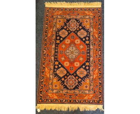 Iranian Hamal Ziegler hand knotted rug. Red/ orange ground. Hexagonal medallion on a dark blue field within a triple banded b
