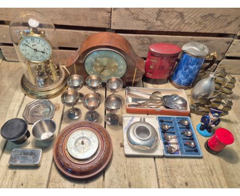 Crate of collectables; Smiths mantel clock, Schatz German brass mantel clock with glass dome, Silver plate goblets, coffee be