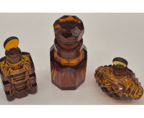 A Collection of three Amber glass art Deco perfume bottles with stoppers 