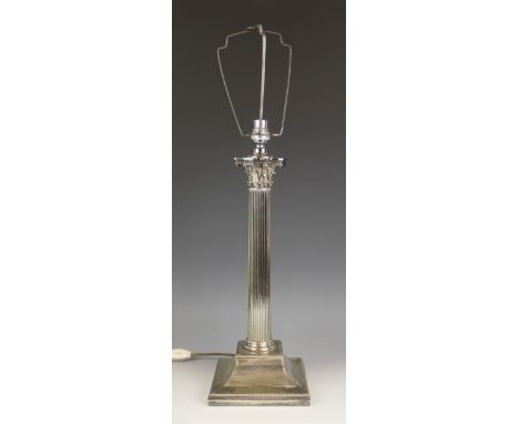 A silver plated Corinthian column lamp base, of typical fluted form, the column extending to an integral plinth base applied 