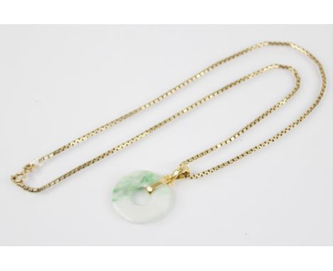 A jade bi-disc pendant, the circular plain polished disc with rope form pendant bale, marked '18k', 2.6cm in diameter, upon a