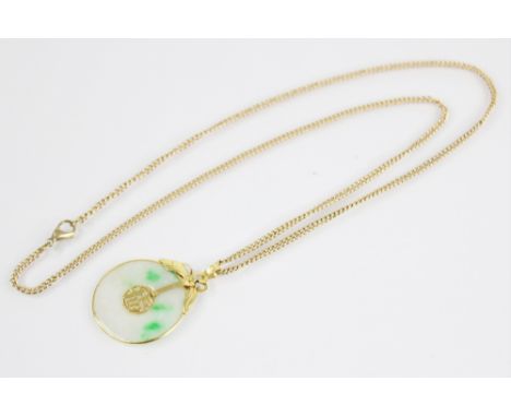 A jade bi-disc pendant, of circular plain polished form, with 'Fu' character to centre, set to a gold coloured mount with bow