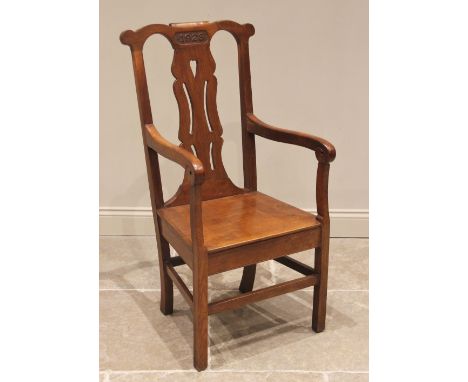 A 1923 oak Eisteddfod chair, the top rail carved with the year above a pierced splat and board seat, enclosed by down swept o