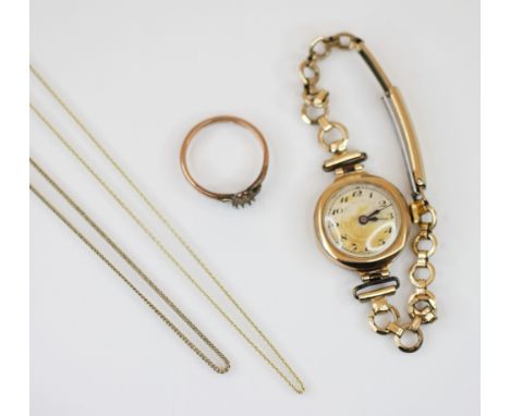 A ladies 9ct gold wristwatch, the circular cream dial with engine turned detail and Arabic numerals, set to a faceted bezel a