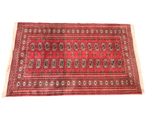 A Bokhara wool carpet, decorated with a repeating geometric gulls against a red ground, 153cm x 93cm 