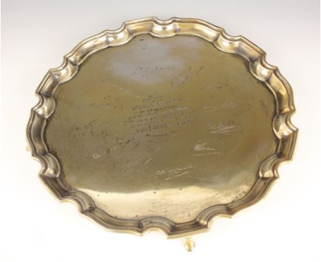 A George VI silver presentation salver, Ernest W Haywood, Birmingham 1947, of circular form with Chippendale border on four r