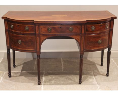 A George III mahogany bowfront sideboard, the shaped top centred with a conch shell enclosed by satinwood crossbanding, the c