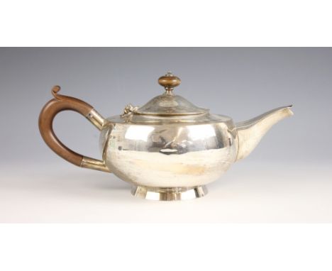 A George V silver teapot, Hukin and Heath Ltd, Birmingham 1924, of compressed globular form on raised circular foot, with com