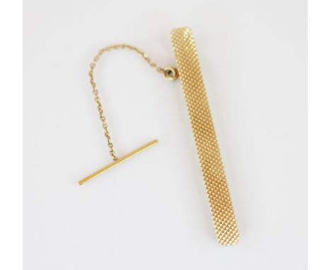 A 14ct yellow gold tie clip, with engine turned decoration to the front with plain polished clip, attached safety chain, 4.9c