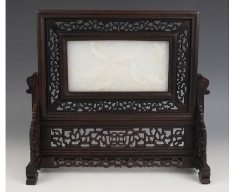 A Chinese white jade inset table screen, the rectangular panel carved in relief depicting Koi fish, enclosed by an extensive 