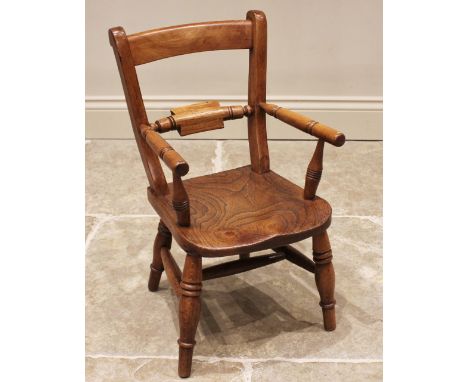 A Victorian elm and beech child's elbow chair, the rail back over a shaped and figured elm seat, upon ring turned tapering le