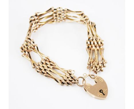 An early 20th century yellow metal gate link bracelet, designed as alternating gate link and brick link sections with engine 