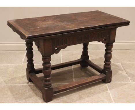 A 17th century style oak draw leaf table, late 19th century, the rectangular cleated slab top with two draw leaves above a le