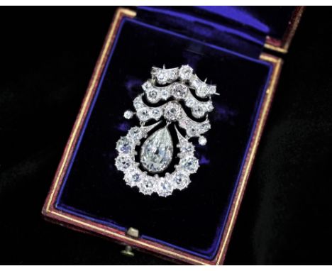 An early 20th century diamond drop pendant brooch, the central pear cut diamond weighing an estimated 2.25 carats, estimated 