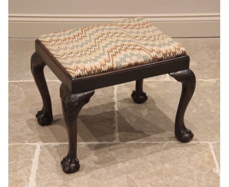 A Chippendale revival mahogany dressing stool, early 20th century, the rectangular upholstered drop-in seat, raised upon leaf