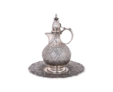 A TURKISH SILVER EWER AND TRAY
Densely decorated in repeated foliate panels on finely chased ground, marked '900' by maker 'R