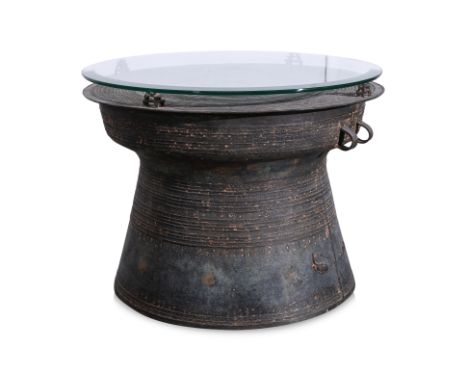 A SOUTH EAST ASIAN BRONZE CEREMONIAL RAIN DRUM WITH GLASS TOP
Bronze alloy, circular drum with flat overhanging rim and evert