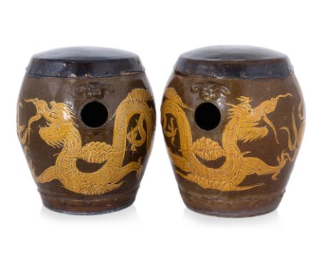A PAIR OF DRAGON STOOLS
Stoneware barrel form stools decorated in two dragons chasing flaming pearl, mythical beast mounts to