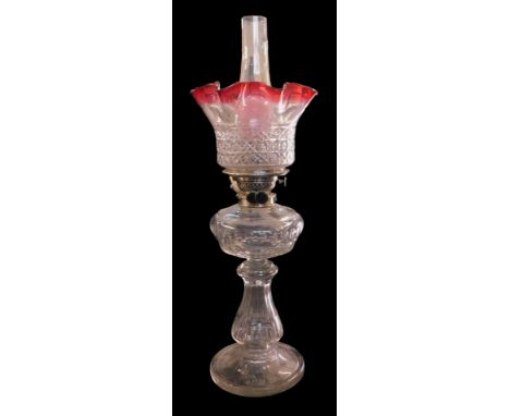 A 20thC Doty's Captain Duplex cut glass oil lamp, with a clear and cranberry glass shade, clear glass central reservoir, cyli