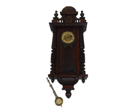 An early 20thC walnut cased Vienna wall clock, the brass dial with cream enamel chapter ring, eight day movement, with pendul