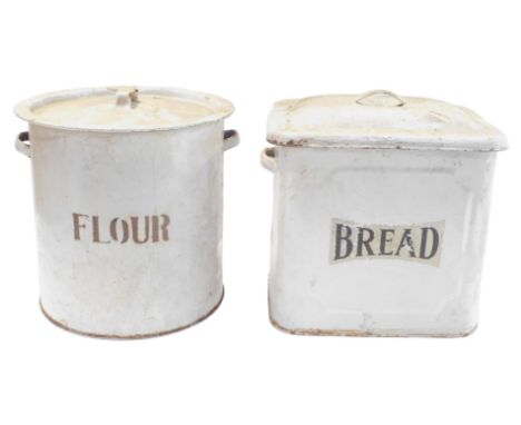 A mid 20thC white enamel bread bin, with lid, 30cm high, and a flour bin, of round form, with lid. (2)