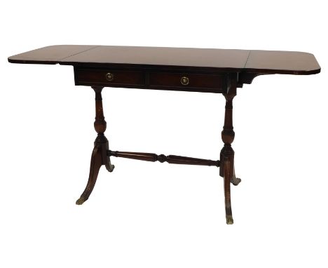 A 20thC mahogany sofa table, in Regency style, the top with a rounded edge above two frieze drawers, on turned columns, on ou