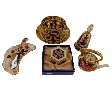 A group of Royal Crown Derby imari porcelain, including a teacup and saucer, bell, butter knife, miniature teapot, trinket di