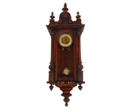 An early 20thC walnut cased Vienna wall clock, the brass circular dial with cream enamel chapter ring bearing Arabic numerals