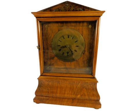 A 19thC walnut cased mantel clock, with a brass circular dial bearing Roman numerals, thirty hour, the case of architectural 