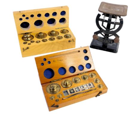 A set of Bilateral weighing scales, and two cased sets of weights.