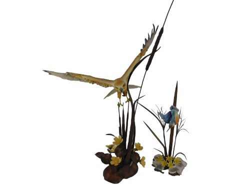 A Boehm of Malvern porcelain and cast metal bird figure, modelled as a Marsh Harrier in flight above porcelain flowers and ca