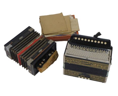 A Hohner accordion, together with an Antoria The Victor squeezebox and various sheet music, contained in a box.