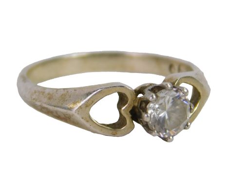 A silver dress ring, set with an imitation diamond, on heart shaped shoulders, white metal stamped silver, ring size K½, 1.9g