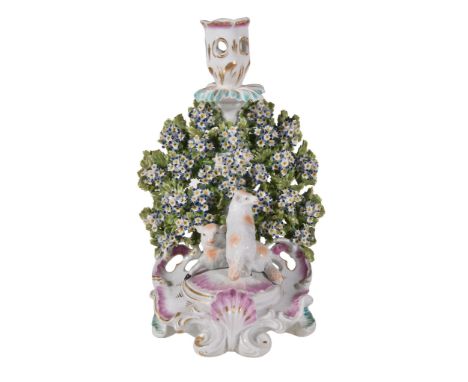  A Derby porcelain bocage candlestick group,   circa 1765, two lambs modelled recumbent on a  rocaille   base, paper label fo