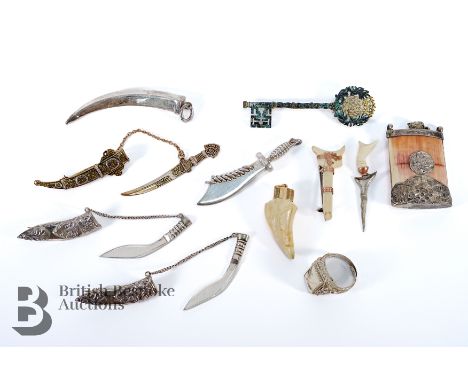 Miniature silver and silver metal kukri brooches and a kukri pendant together with bone items, a gentleman's silver ring and 