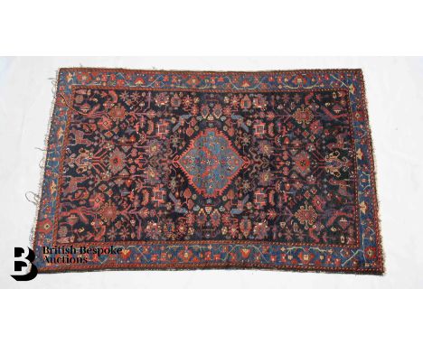 Persian wool carpet, dark blue field worked with flowers, exotic birds and a pale blue central medallion enclosed by a royal 