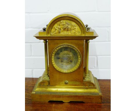 Ormolu mantle clock with cherub frieze to the arched top, with silvered chapter ring, flanked by columns, on a rectangular ba
